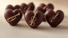 image of chocolate heart candies decorated with miniature instruments