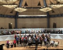 members of the Community Chorus standing on stage