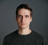 Photo of man in dark shirt.