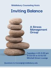 Six flat stones are balanced in a column against a light blue background.