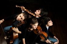 the artists sitting in a circle with their instruments, viewed from above