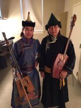 two musicians standing next to each other holding their instruments