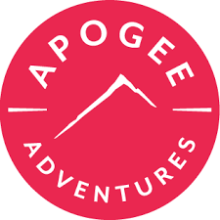 Pinkish red circle with apogee adventures in white letters and outline of mountain