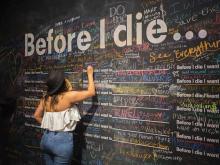 Person writing on a chalk wall