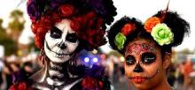 Two people faces painted as skeletons for Day of the Dead