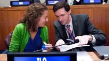 Emily Welty and Matthew Breay Bolton confer at their table at a United Nations convening