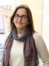 Women wearing glasses and scarf smiling