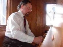 man in white shirt playing carillon
