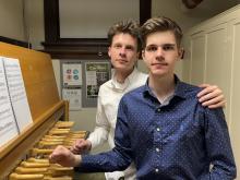 Brothers in blue and white shirts at carillon