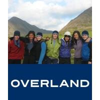 group of students standing in front of mountains