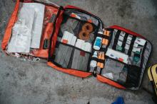 A first aid kit with various first aid supplies.