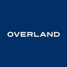 Blue square with white lettering in center, all caps OVERLAND