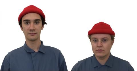 2 men dressed in blue denim with red caps