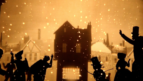 house on a snowy night with shadow figures in the foreground