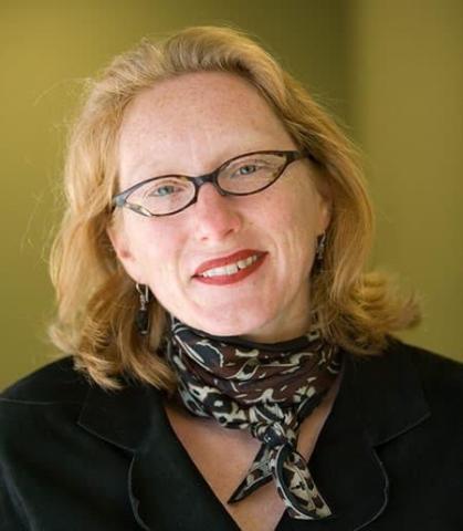 Image of a person wearing glasses and a scarf