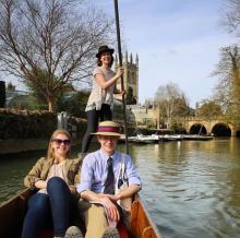 Photograph of three people in a gondola in a canal
