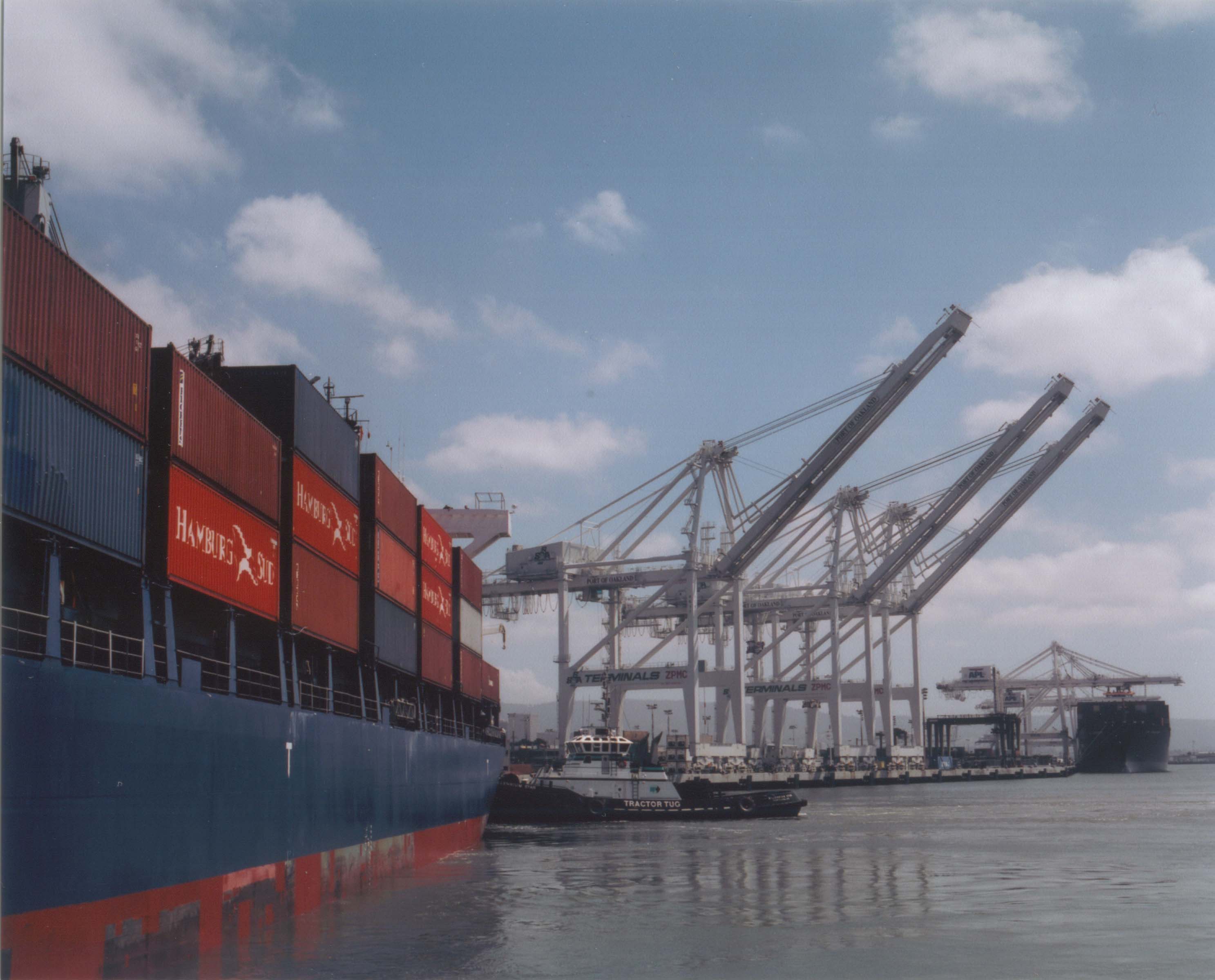 Container ship approaching offloading cranes SF or Oakland Bay Area CA