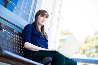 Student with laptop outside Kinnoull House