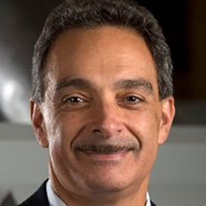Dr. Habib-Dagher, a tight head shot, he is smiling but not showing teeth, has a mustach, and kind, intelligent eyes.
