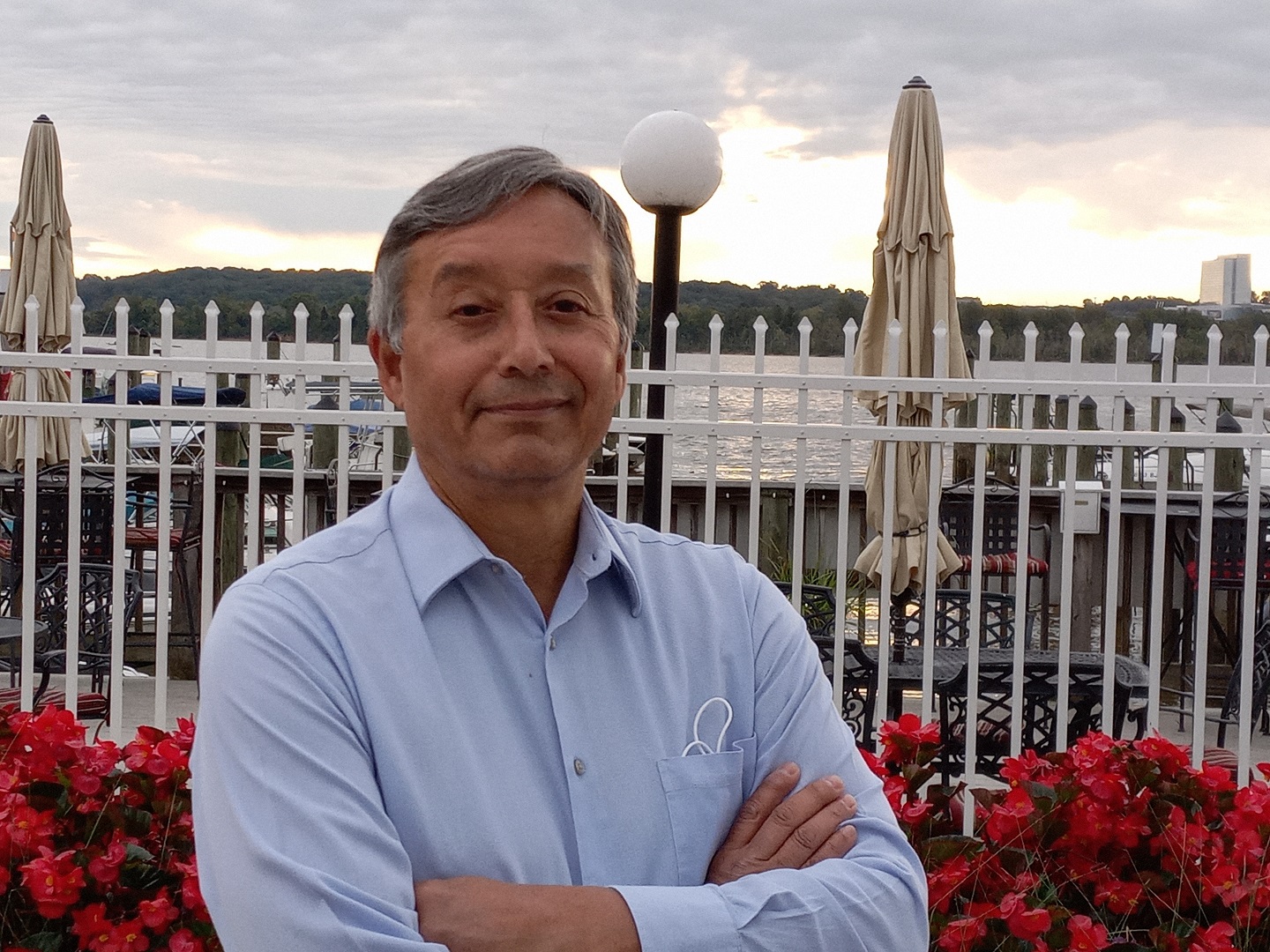 Man standing outside with his arms folded looking at the camera