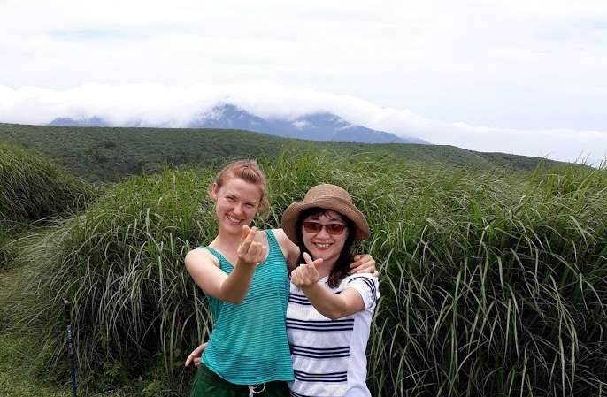 Jordyn Dezago and friend standing in a field.