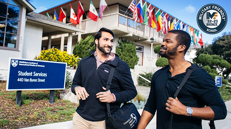 Two students walking. Military Friendly Bronze Award logo in corner.