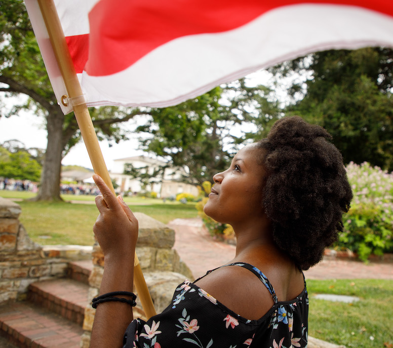 Student carrying flag at procession