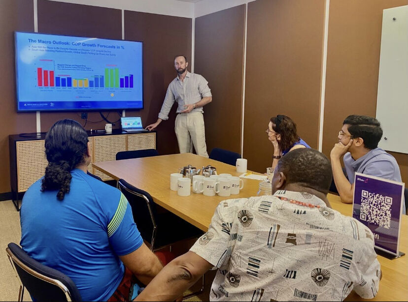 A man presenting in front of some people
