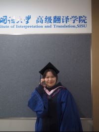 Jasmine in her graduation regalia posing proudly