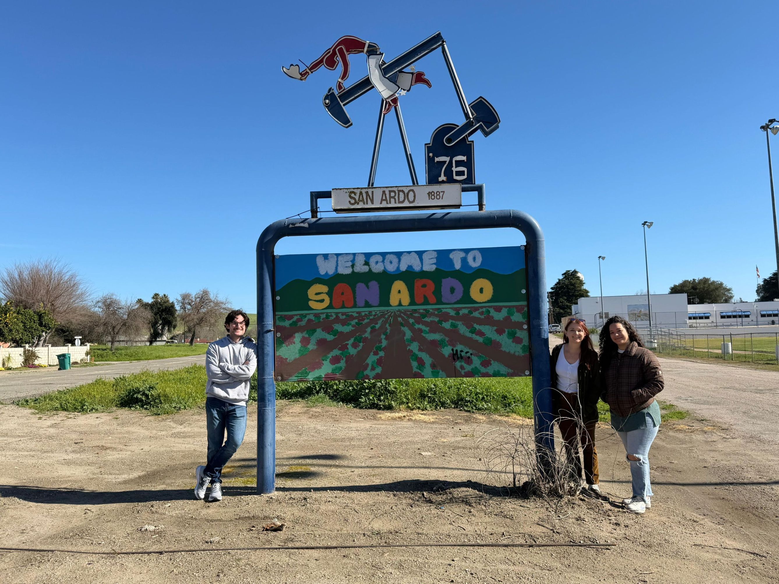 TAMC student fellows pose at the San Ardo entrance sign during a street safety field trip