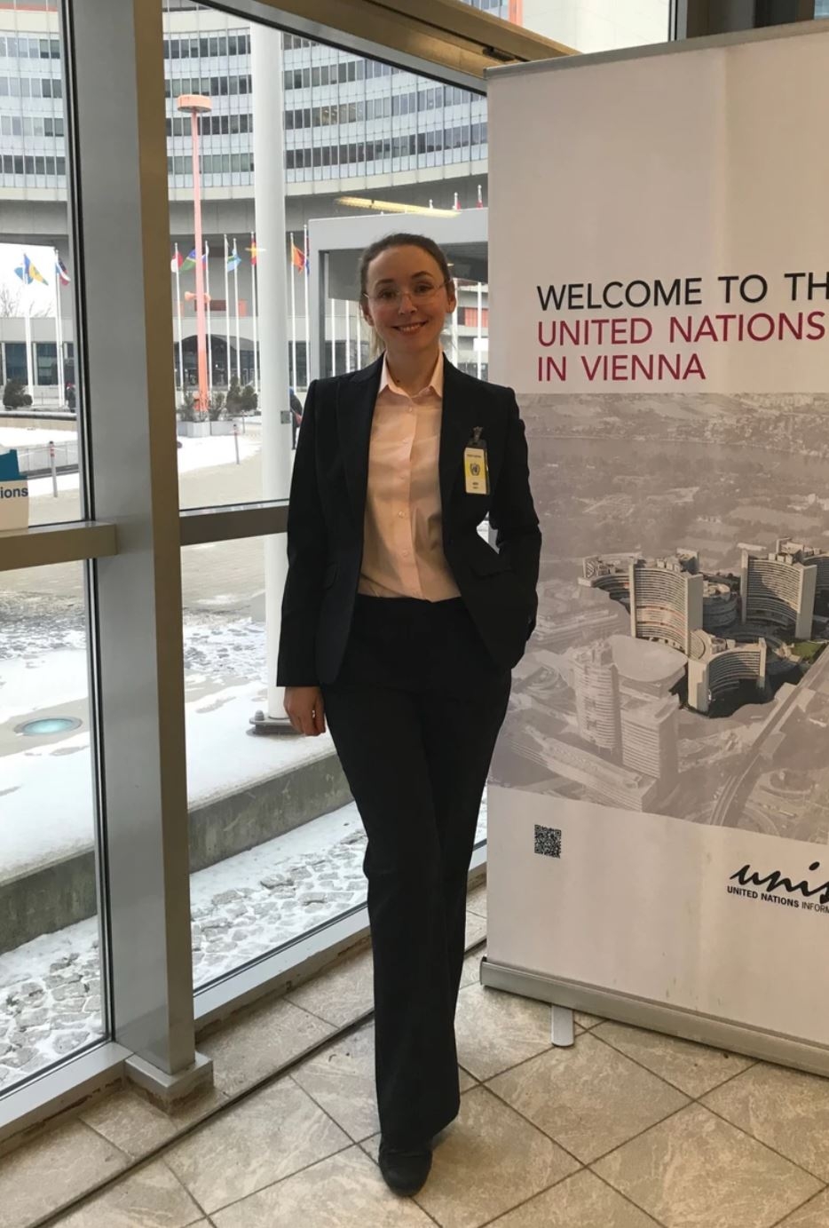 Irina Yarovaya, a dual degree MIIS-MGIMO student stands in front of a sign at the International Atomic Energy Agency (IAEA)