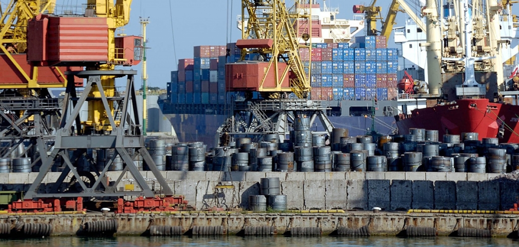 Photo of the Port of Los Angeles with container ships and barrels stacked high