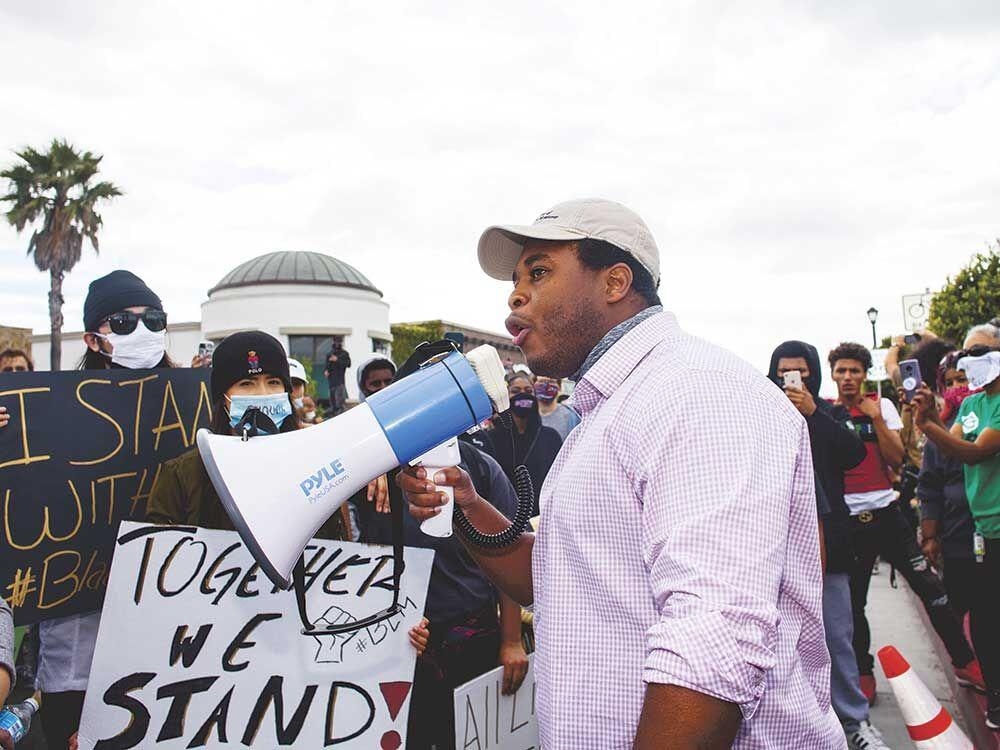 Nathaniel Sawyer speaking into megaphone at rally