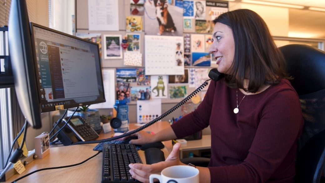 Natalie Spencer sitting at her work desk at the American Councils for International Education