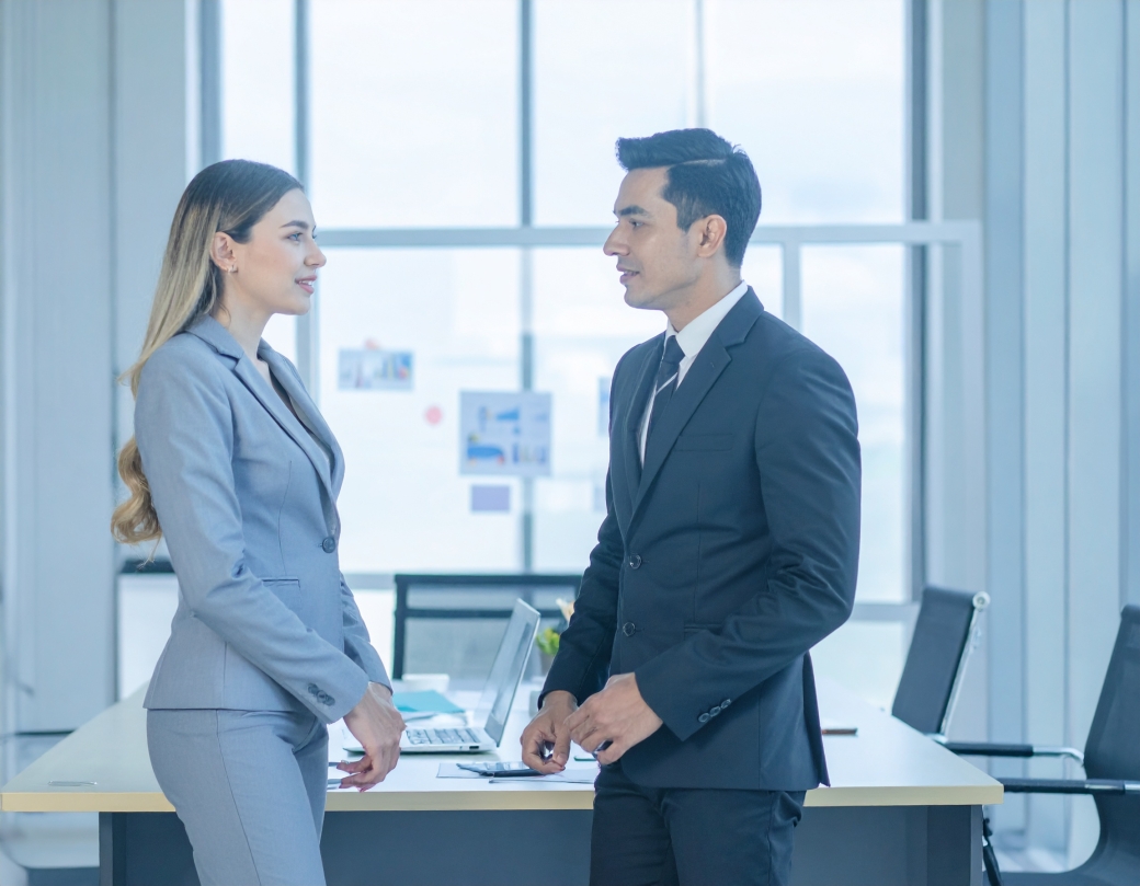 Man and woman talking in professional setting