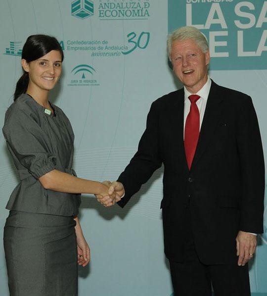 Paula Manrique shakes hands with former U.S. President Bill Clinton