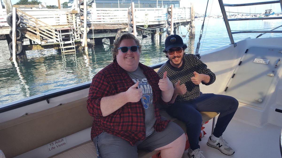 people on a catamaran sailing boat, about to set sail for two hours, looking happy, smiling