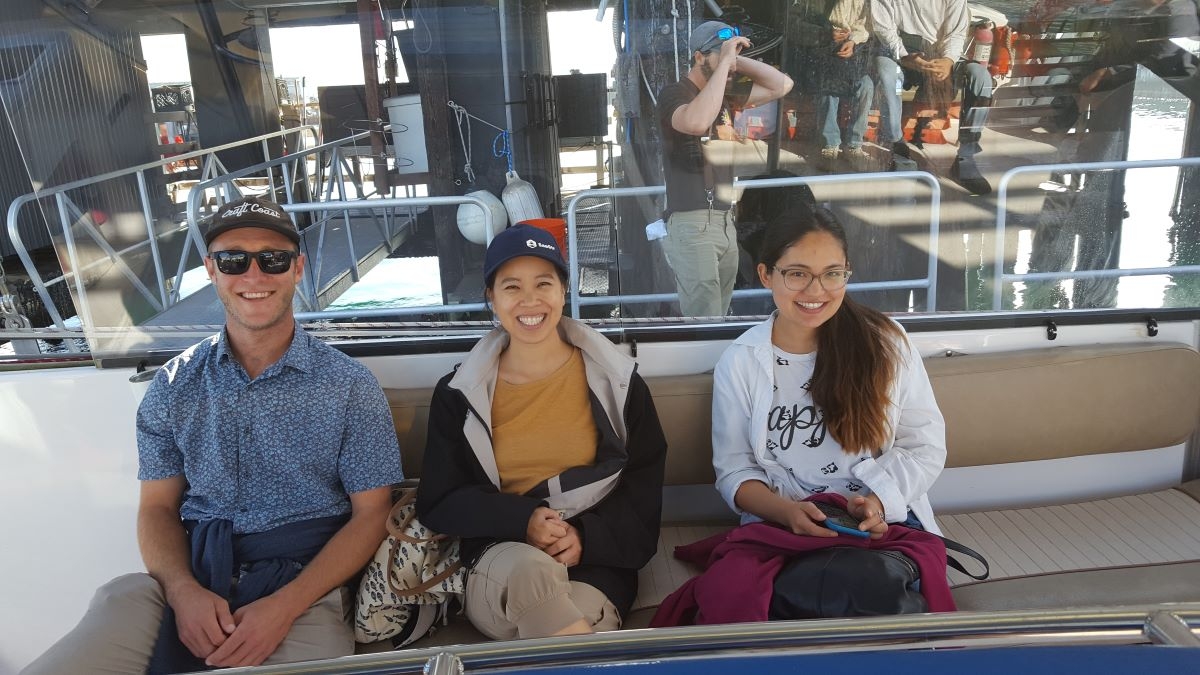 people on a catamaran sailing boat, about to set sail for two hours, looking happy, smiling