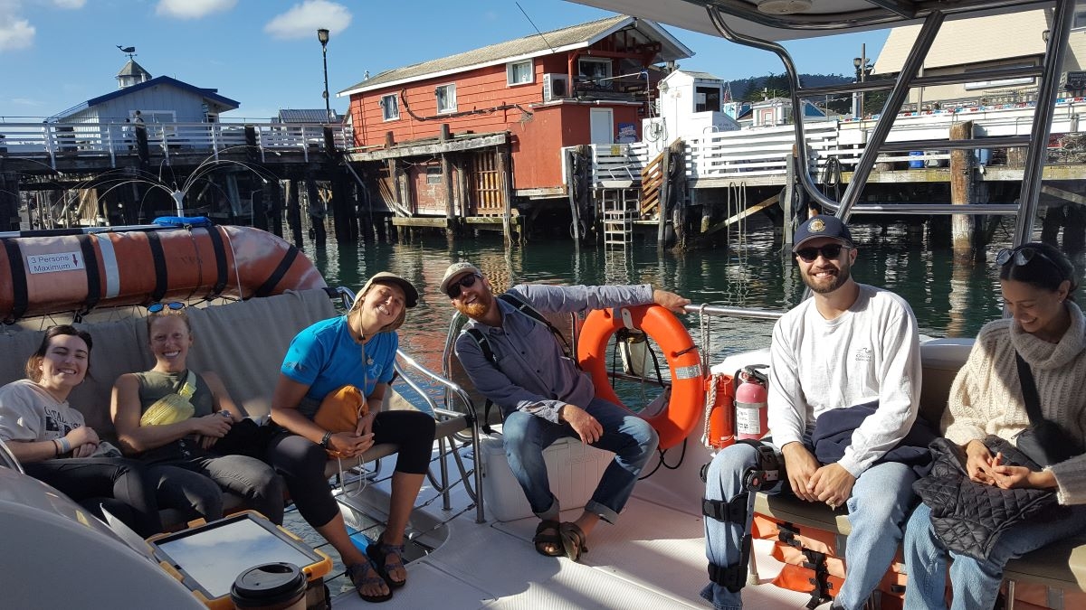 people on a catamaran sailing boat, about to set sail for two hours, looking happy, smiling