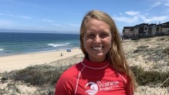 a student standing on the beach