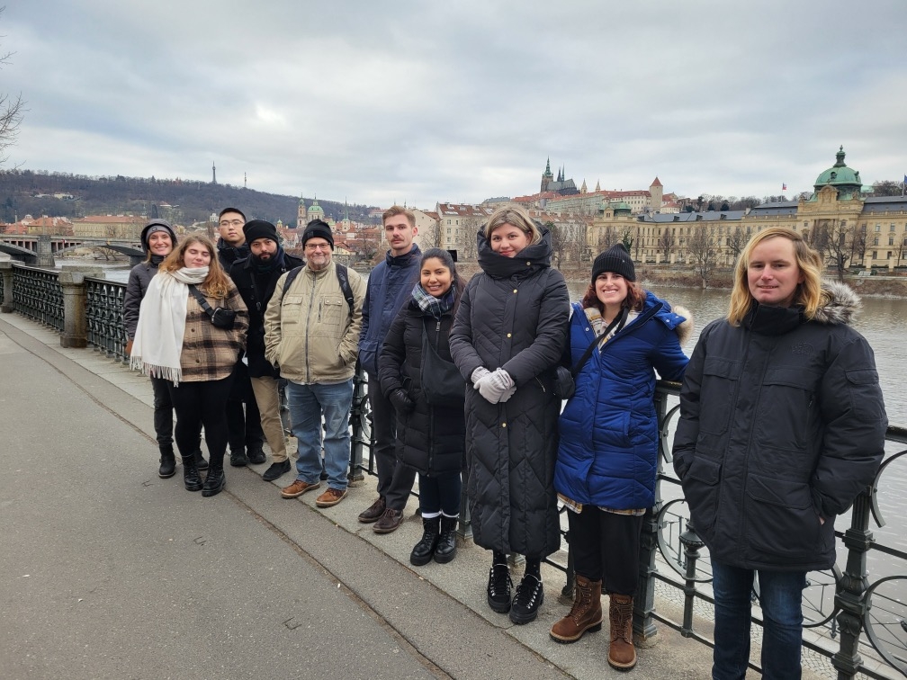 group of students posing in front of historic sights