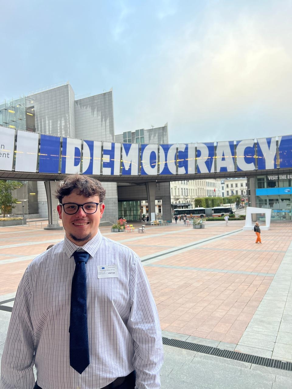 theo standing in front of a sign