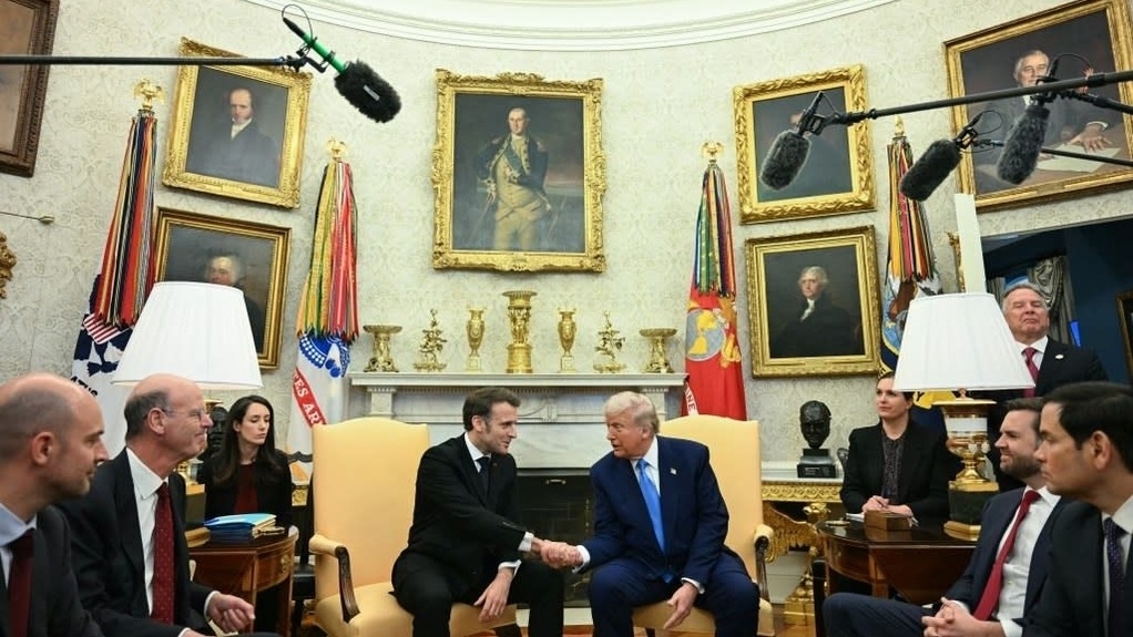 President Macron and President Trump with interpreters and other officials