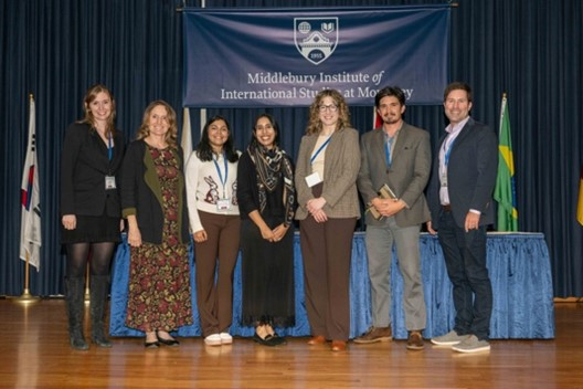 A group of seven people on stage