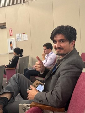 A man sitting giving a thumbs up