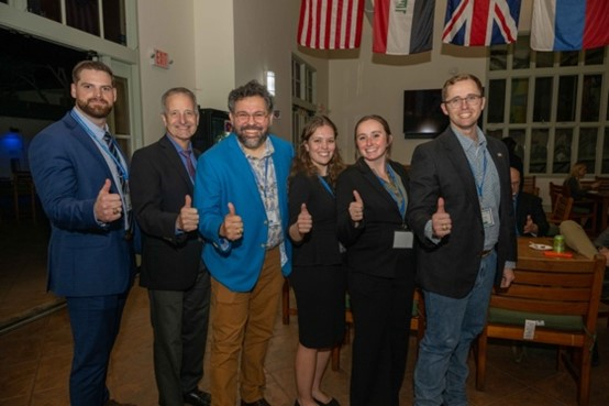 A group of six people with thumbs up