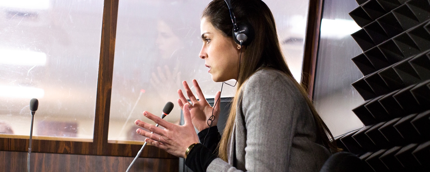 A Translation and Interpretation student works in one of the Institute's state-of-the-art simulation booths.