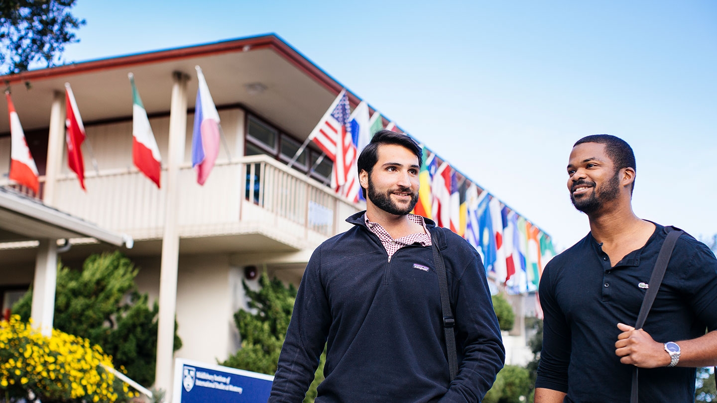 Two students walking on campus