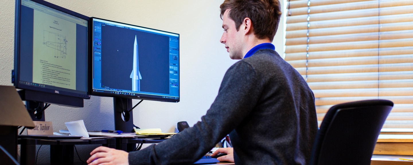 Young male student working at a computer.