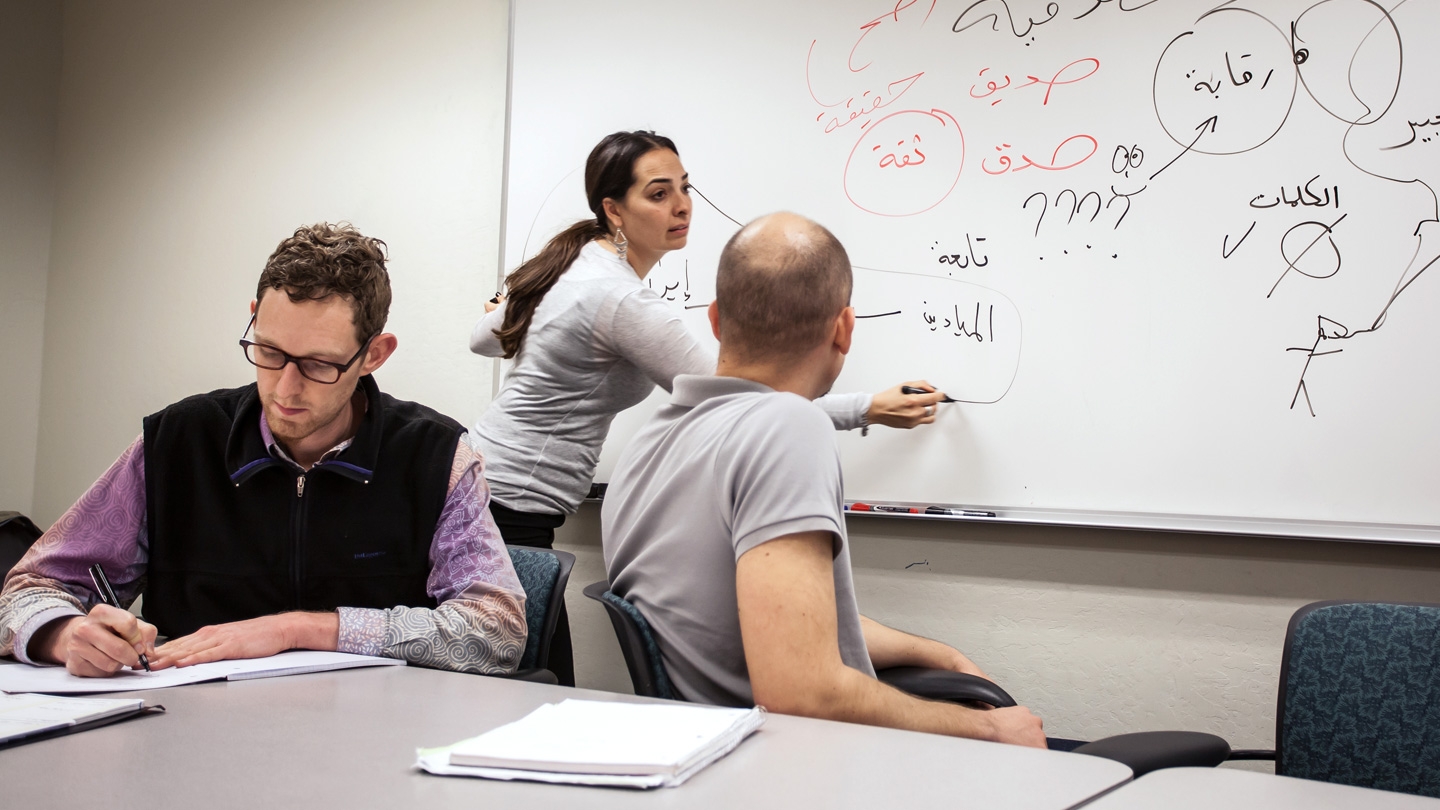 Students work in the classroom translating arabic